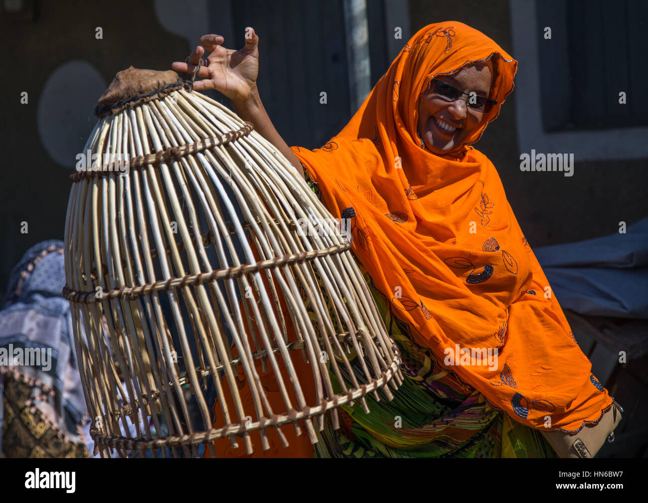 Afar women with a basket used to dry the clothes, Afar region, Assaita