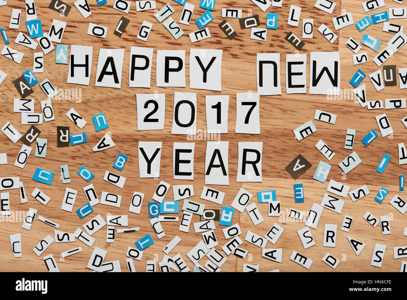 happy 2017 new year word cut out from magazine on wood background Stock Photo