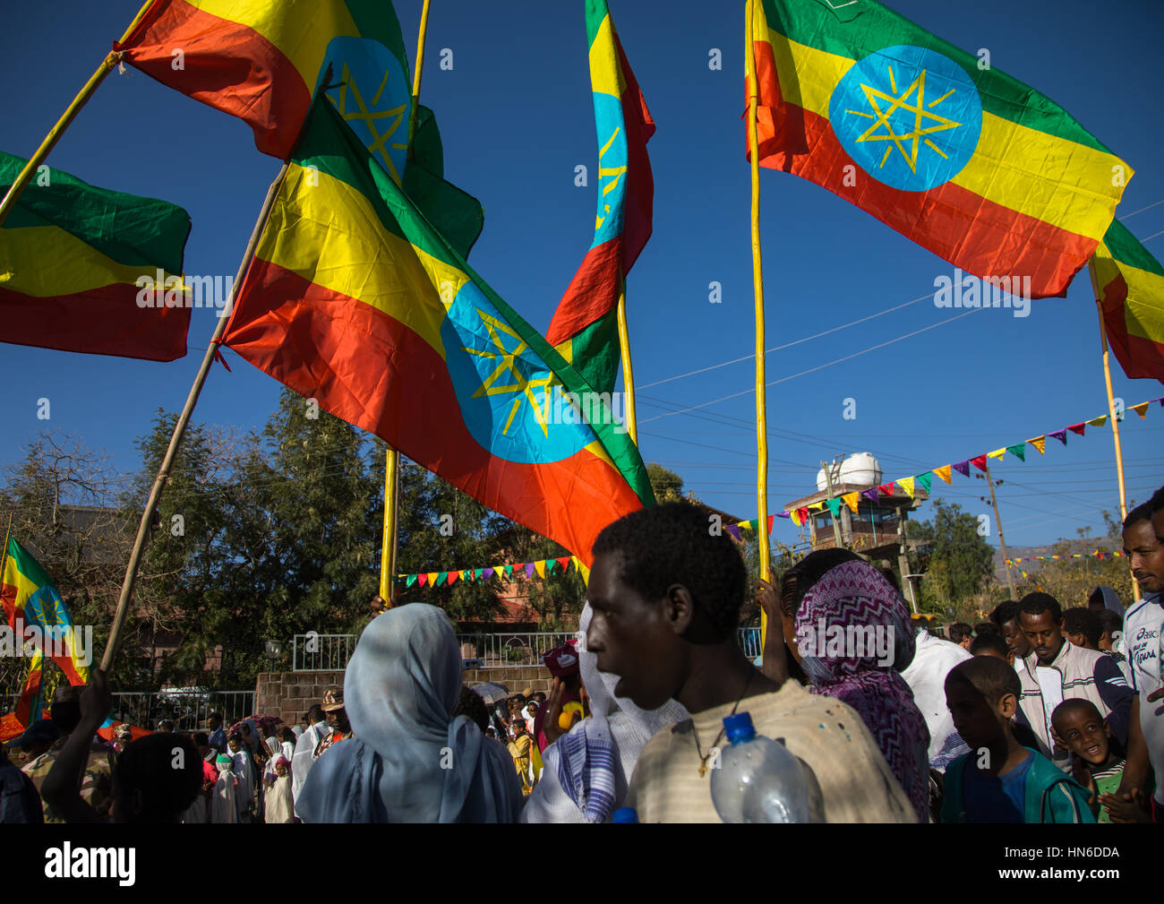 Ethiopian pilgrims carrying ethiopian flags during Timkat epiphany festival, Amhara region, Lalibela, Ethiopia Stock Photo
