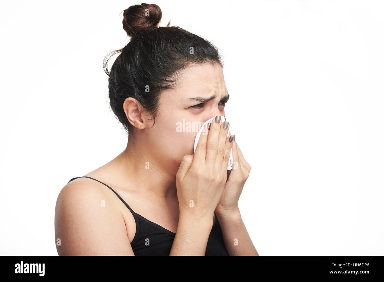 woman with flu blow her nose hard isolated on white Stock Photo