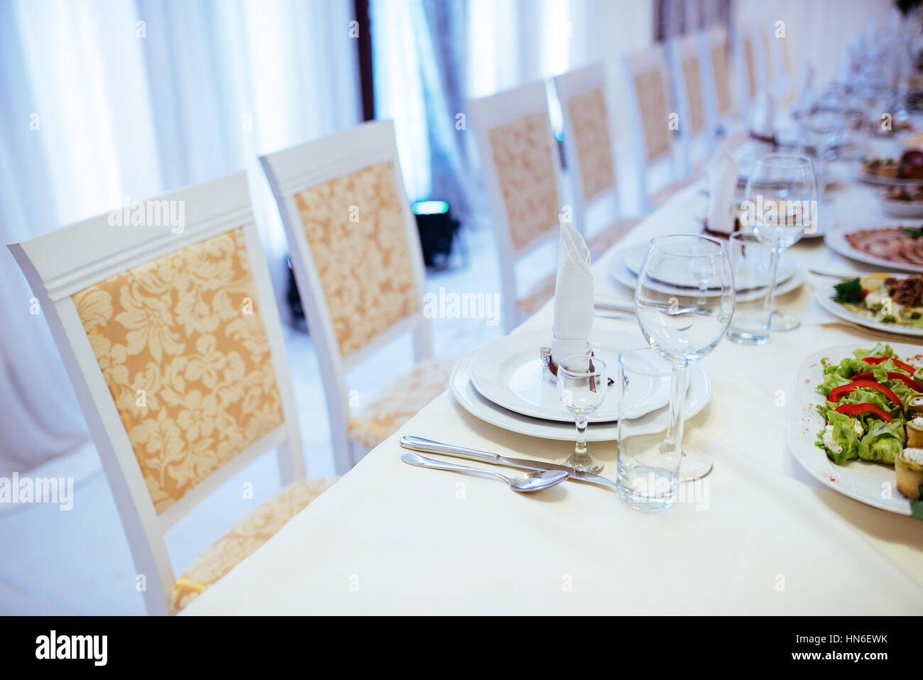 Formal stylish setting on a dinner table with elegant glassware Stock Photo