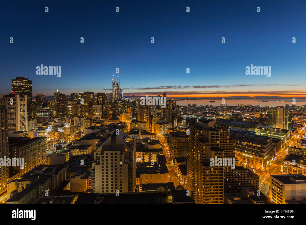 San Francisco, California, USA - January 14, 2017:  Predawn glow behind downtown towers and Mission Bay district. Stock Photo