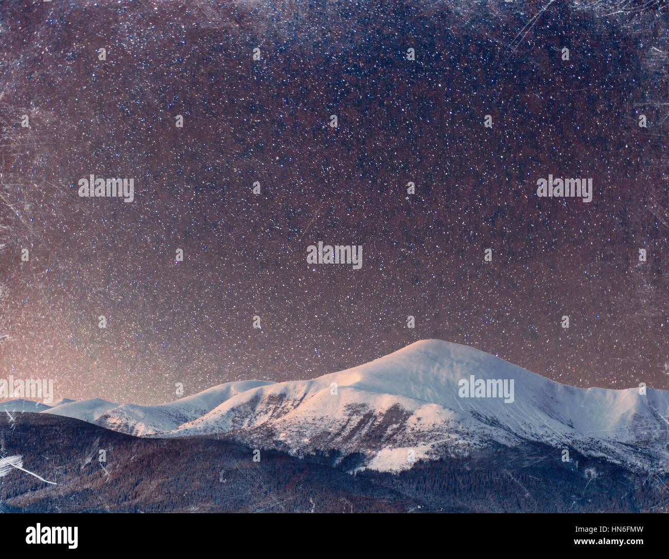 fantastic winter meteor shower and the snow-capped mountains. Vi Stock Photo