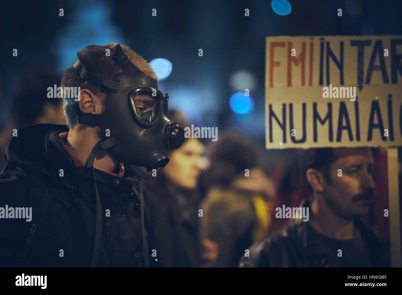 Bucharest, Romania - October 6, 2013: Young man wears gas mask during the mass rallies against the toxic cyanide gold extraction in Rosia Montana Stock Photo