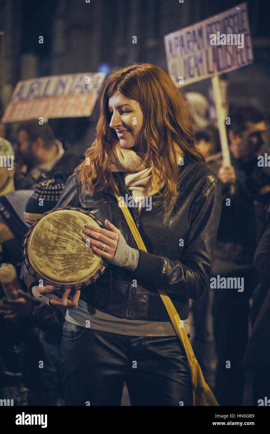 Bucharest, Romania - October 6, 2013: Young woman plays the drum during the population uprising against the cyanide gold extraction in Rosia Montana Stock Photo