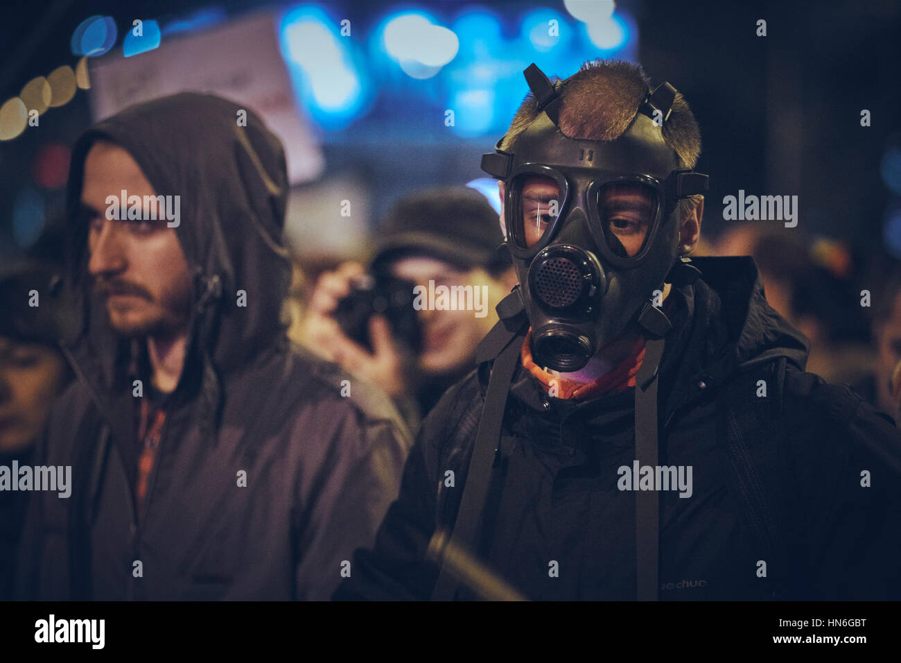 Bucharest, Romania - October 6, 2013: Young man wears gas mask as a protest against the toxic cyanide gold extraction in Rosia Montana, Romania. Stock Photo