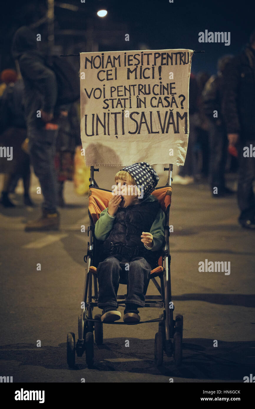 Little child in a baby cart with a slogan sign during the protests against cyanide gold mining in Rosia Montana, October 10, 2013, Bucharest, Romania Stock Photo