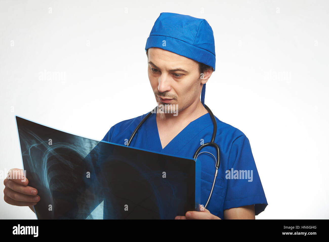 young man doctor hold x-ray photo isolated on white Stock Photo