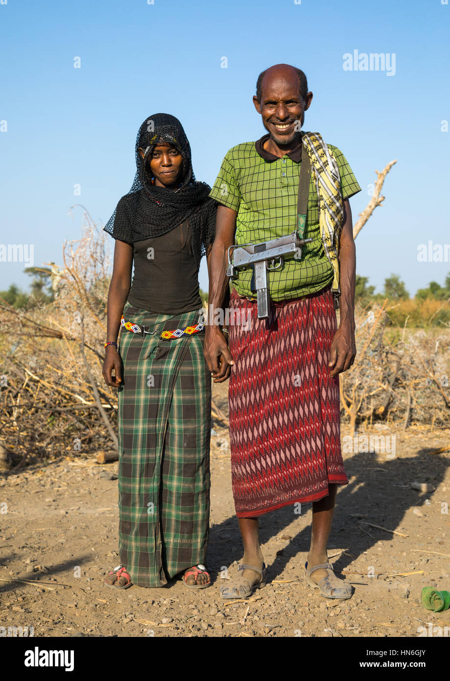 Afar tribe husband with his young second wife, Afar region, Chifra, Ethiopia Stock Photo