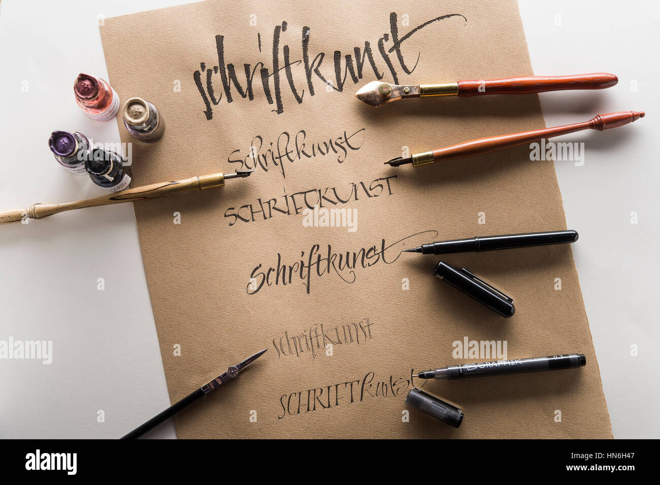 Calligraphy studio, brown Ingres paper, pen and nibs with respective