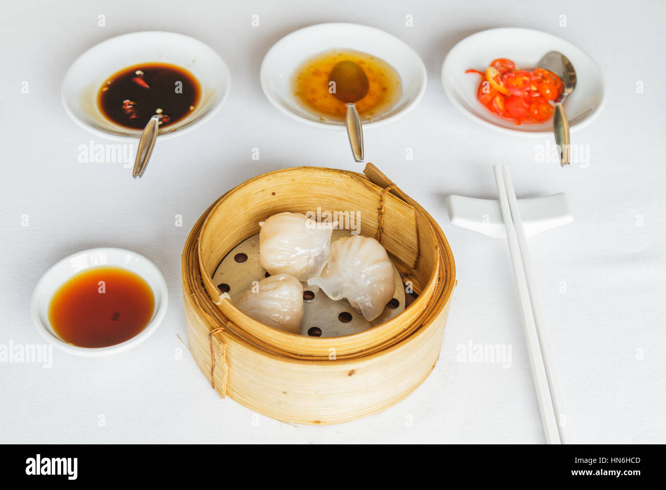 Dim Sum Food Steamed Shrimp Har Gow Dumpling In Bamboo Basket At Restaurant With Soy Sauce Sweet Sauce Chili Sauce And Chopsticks Stock Photo Alamy