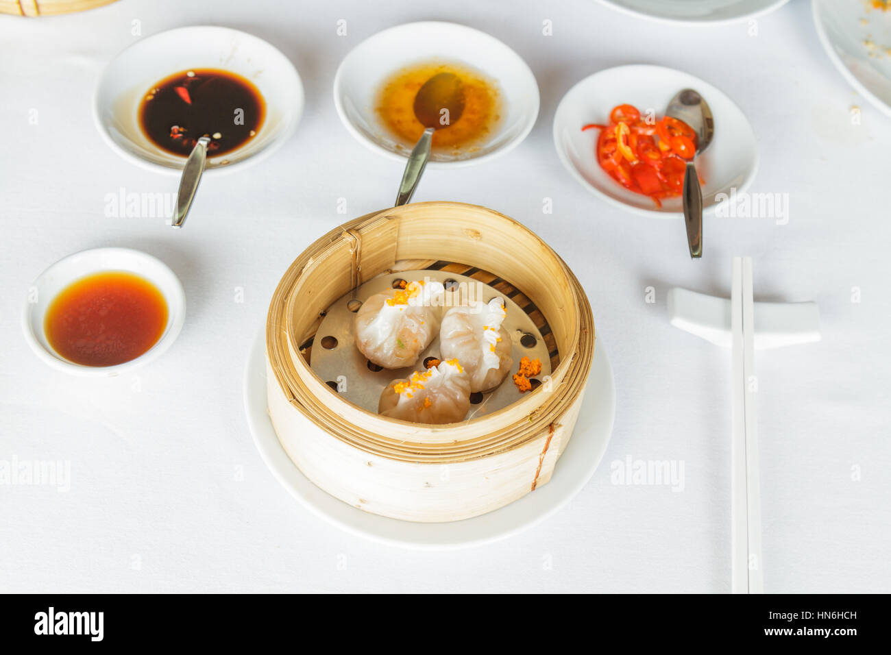 Dim sum food Steamed shrimp Fun Goh dumpling in bamboo basket at