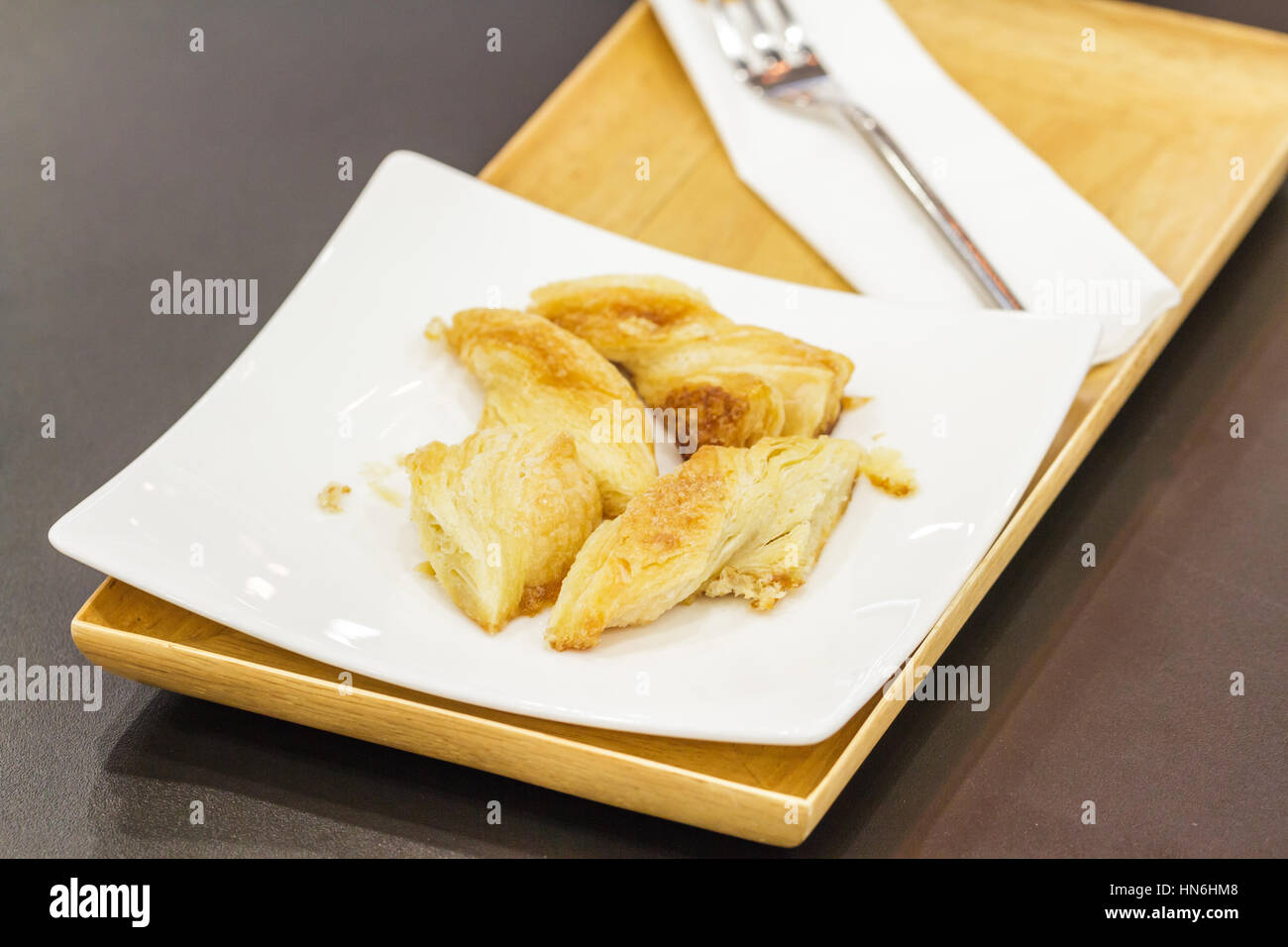 Bread baked cheese slightly salty on wood plate in restaurant. Stock Photo