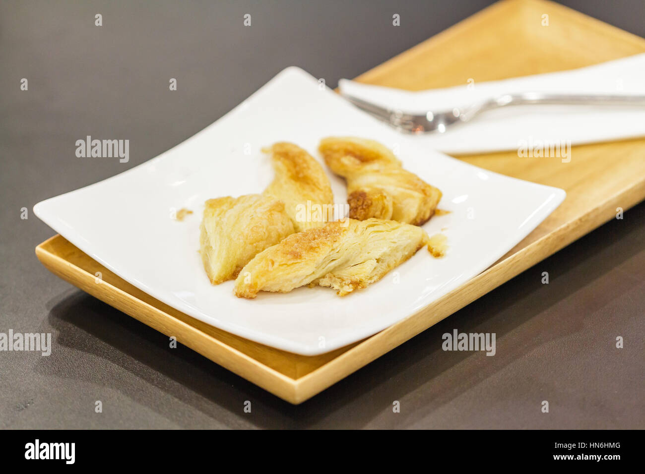 Bread baked cheese slightly salty on wood plate in restaurant. Stock Photo