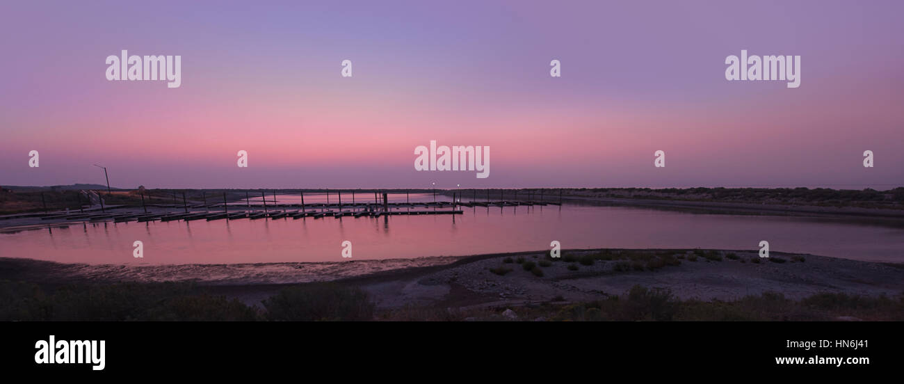 Panorama of pier with beautiful reflection of sunlight after sunset at Antelope Island on Great Salt Lake, Utah. Stock Photo