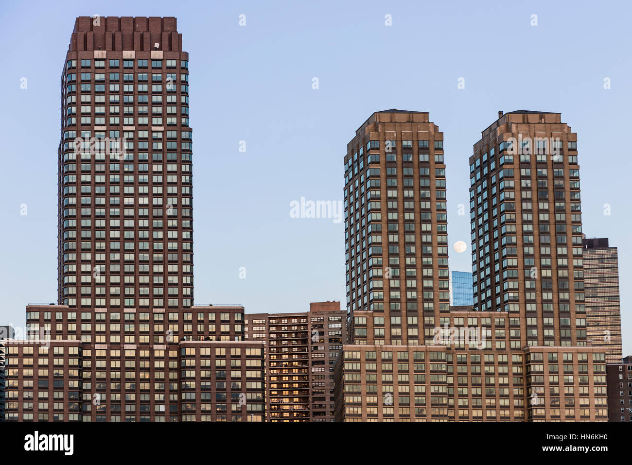 New York, USA - June 18, 2016: Trump residential skyscrapers by Riverfront park during sunset with moon Stock Photo