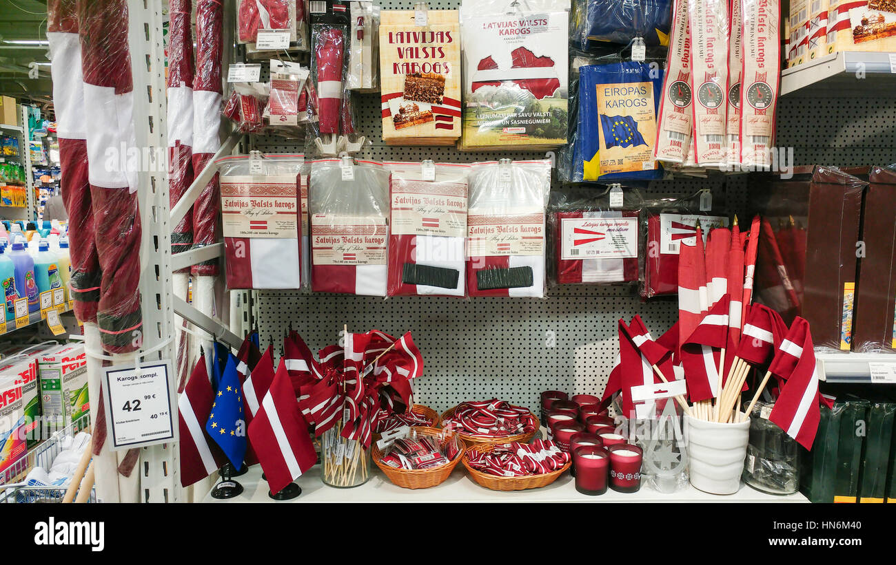 The national flag of Latvia, other national symbols and souvenirs on store shelf. Riga, Latvia, February 9, 2017. Stock Photo