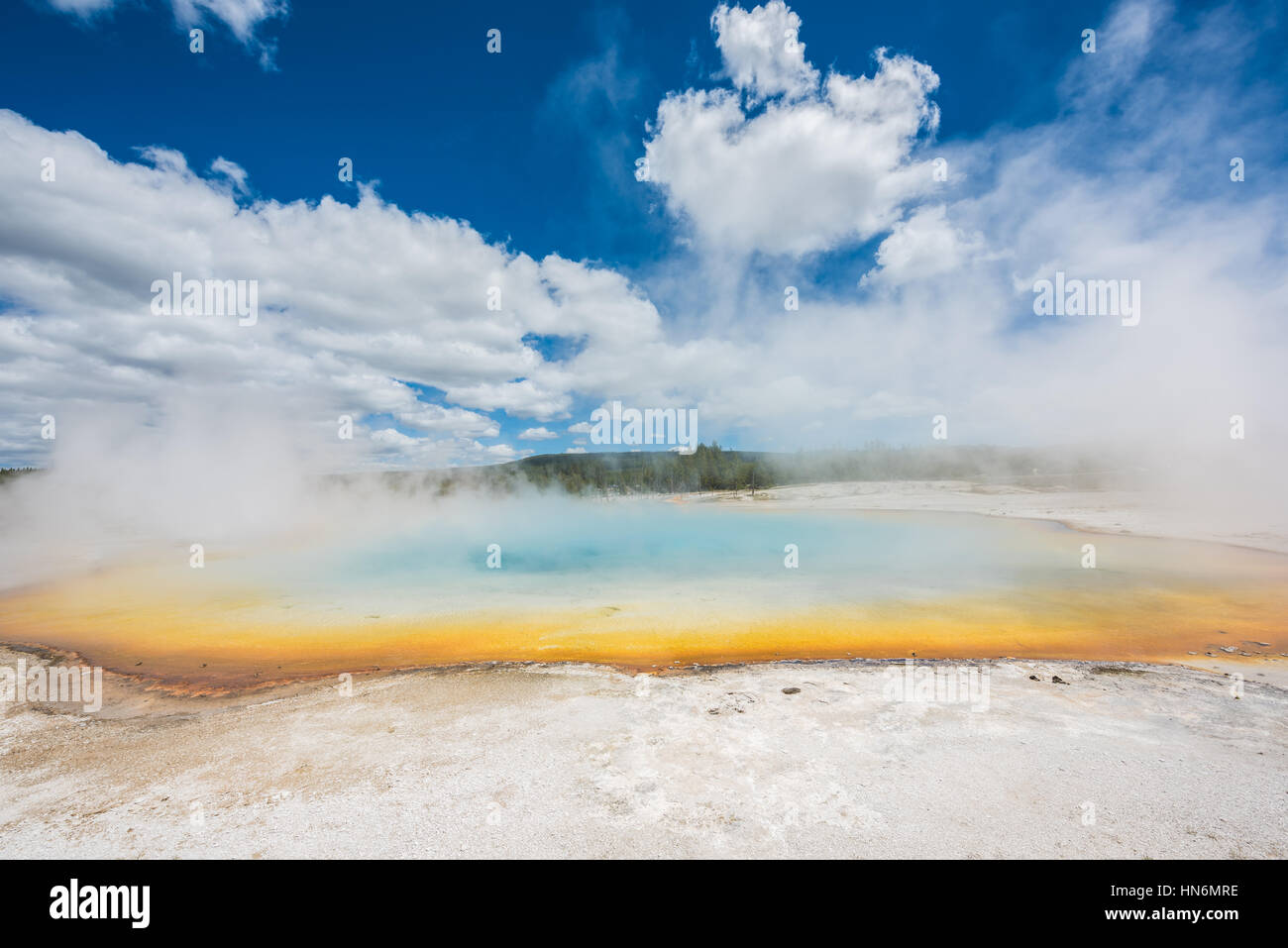 Rainbow pool in Black Sand Basin in Yellowstone National Park with orange and light blue colors with steam rising Stock Photo