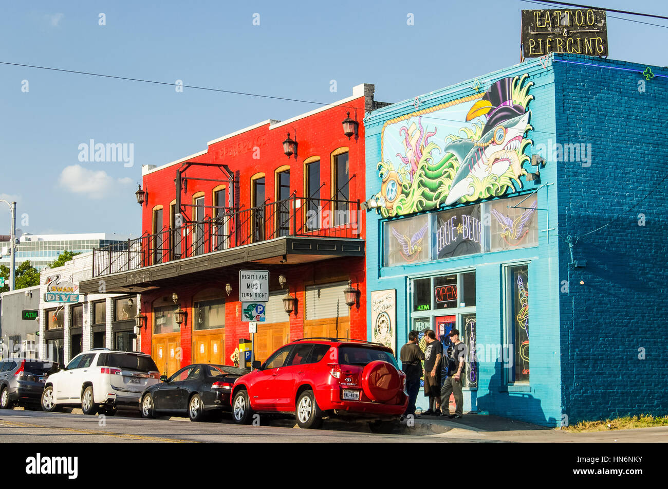 Austin, USA - July 19, 2015: Colorful tattoo and piercing store buildings on street in downtown Stock Photo