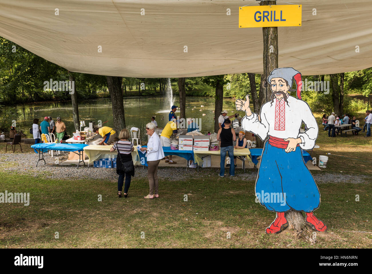 Silver Spring, USA - September 17, 2016: Cut out of Cossack man with grill sign and picnic area at Ukrainian festival Stock Photo