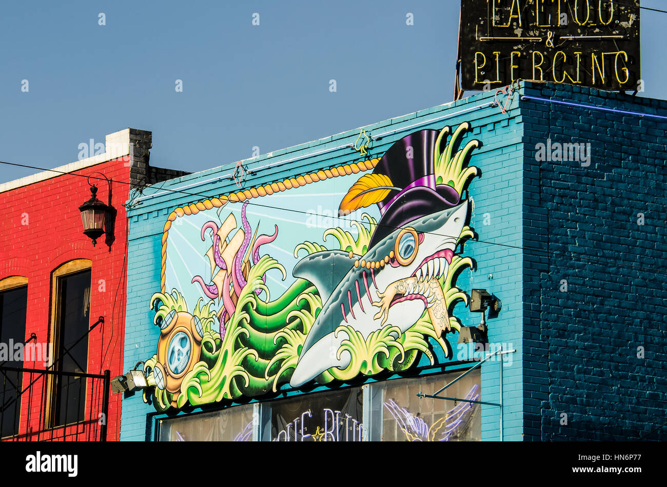 Austin, USA - July 19, 2015: Colorful tattoo and piercing store buildings on street in downtown Stock Photo