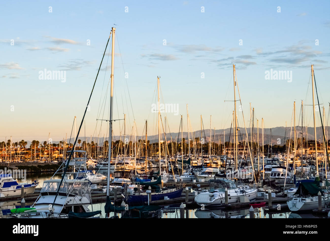 Many boats on marina during sunset with mountains in Oxnard, California Stock Photo