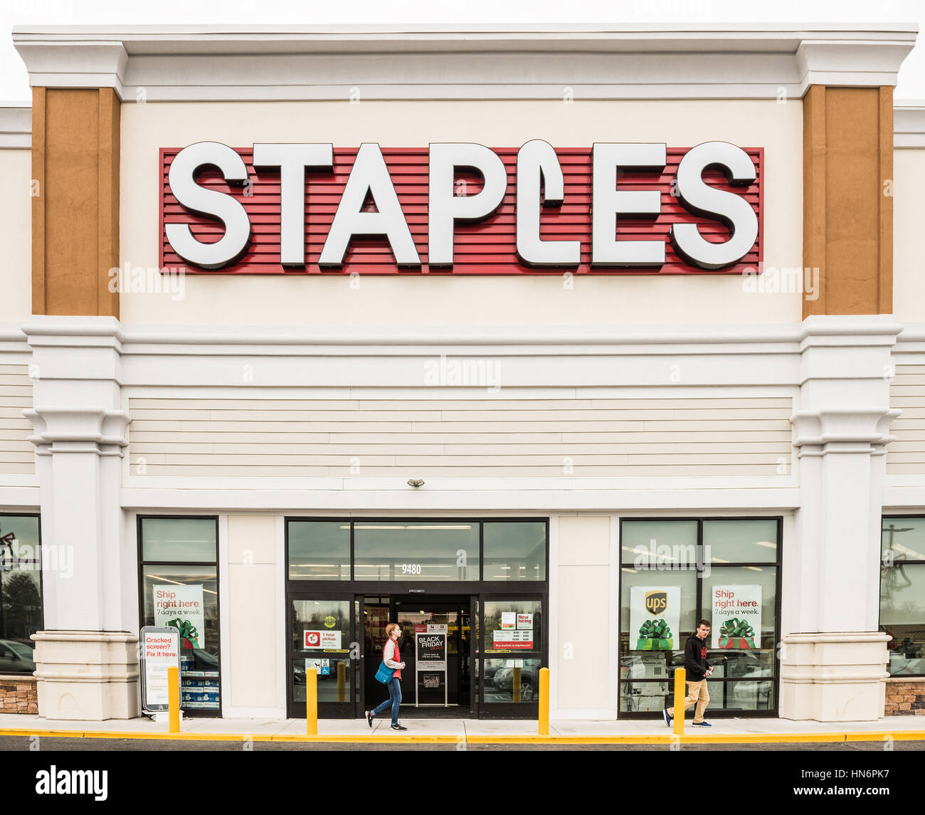 Fairfax, USA - November 25, 2016: Staples store facade with large sign and person walking by entrance Stock Photo