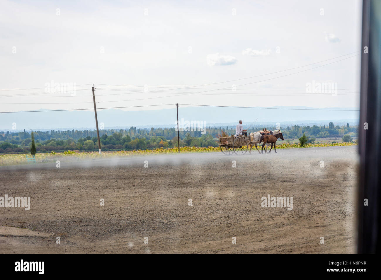 View through car window to horse carriage on the road, Azerbaijan Stock Photo