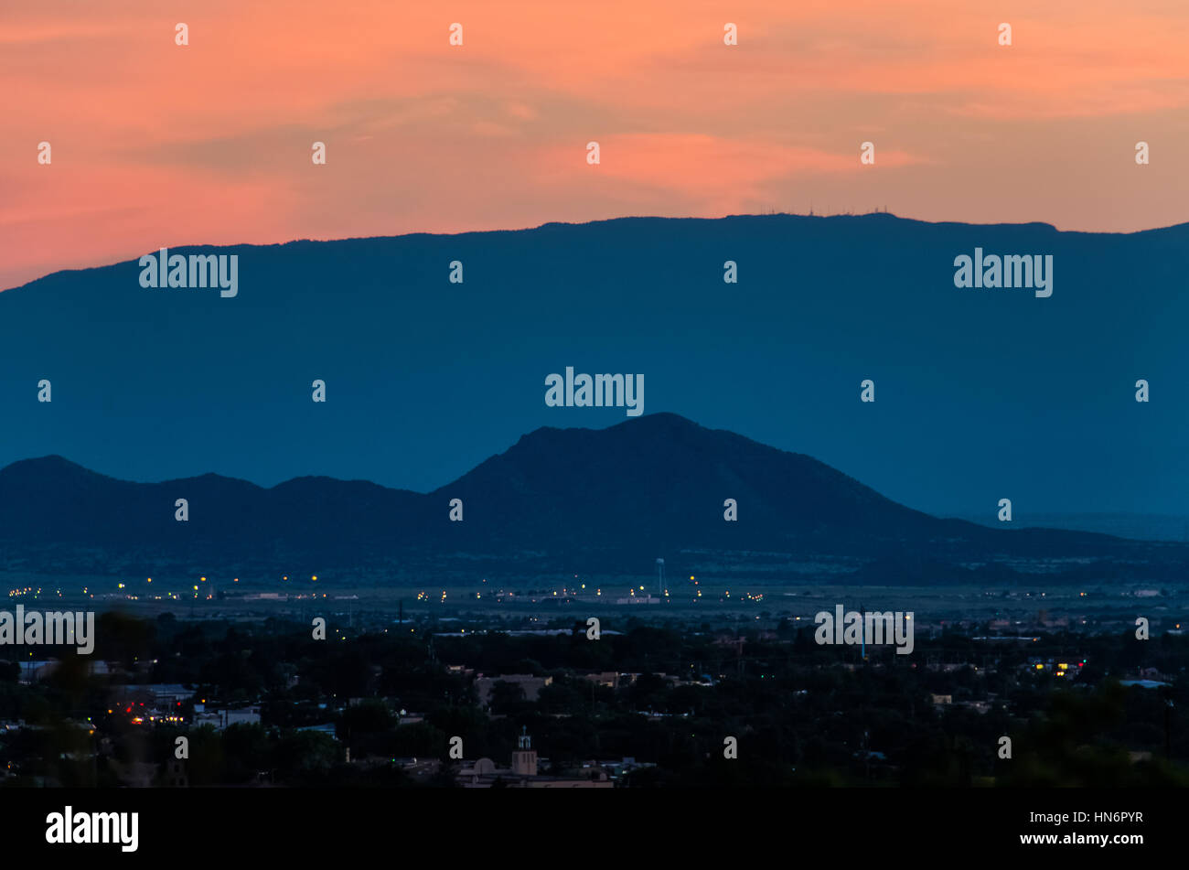 Aerial cityscape of Santa Fe, New Mexico with mountain during pink and blue sunset Stock Photo