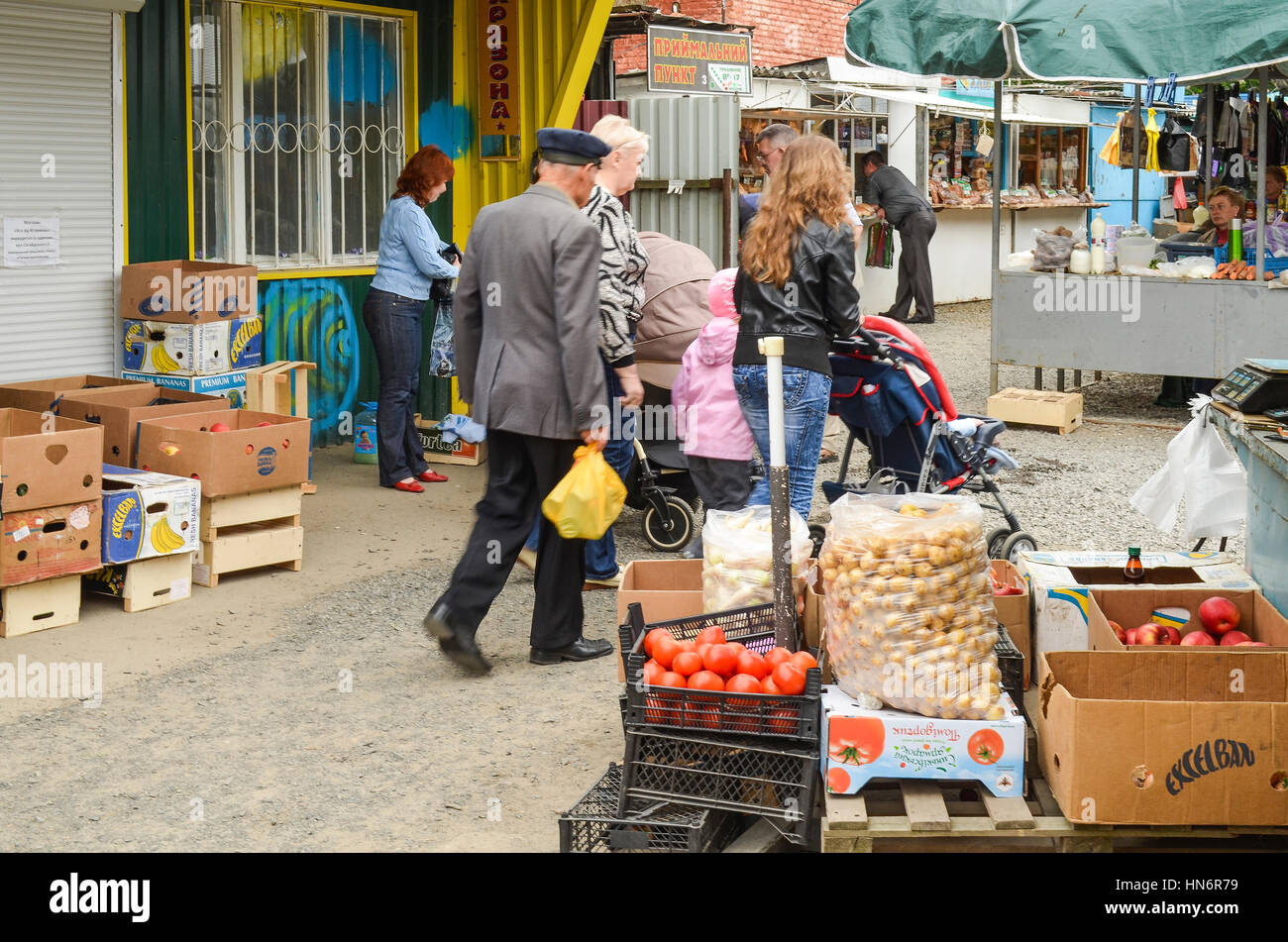 Rivne, Ukraine - May 14, 2013: People at local farmers market or bazaar walking selling and buying fruits and vegetables Stock Photo