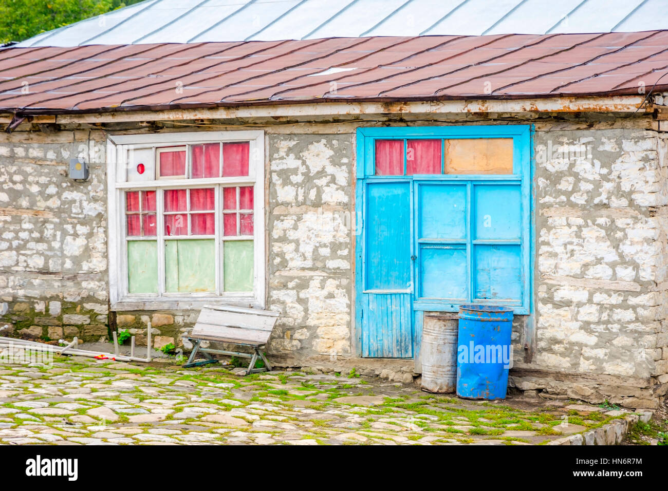 Old house made of stone with colorful windows, Lahich village, Azerbaijan Stock Photo