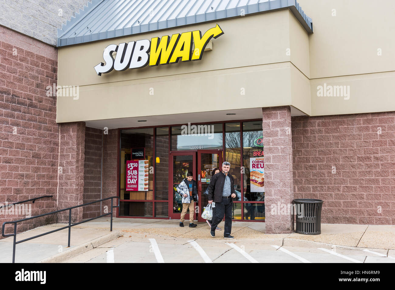 Fairfax, USA - December 11, 2016: Subway sandwich fast food store facade and sign with family walking out Stock Photo