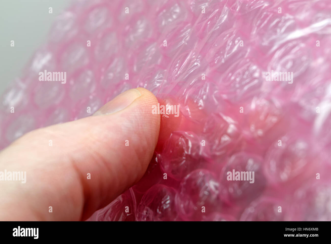 Popping pink bubble wrap Stock Photo Alamy