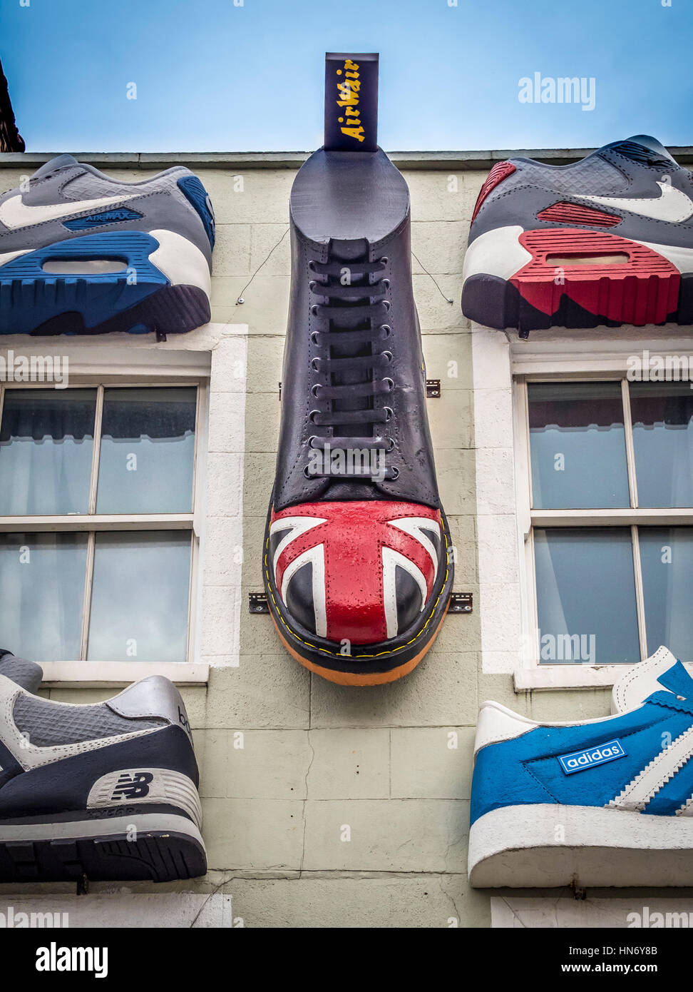 Large shoes on outside of shop in Camden Town centre, London UK. Stock Photo