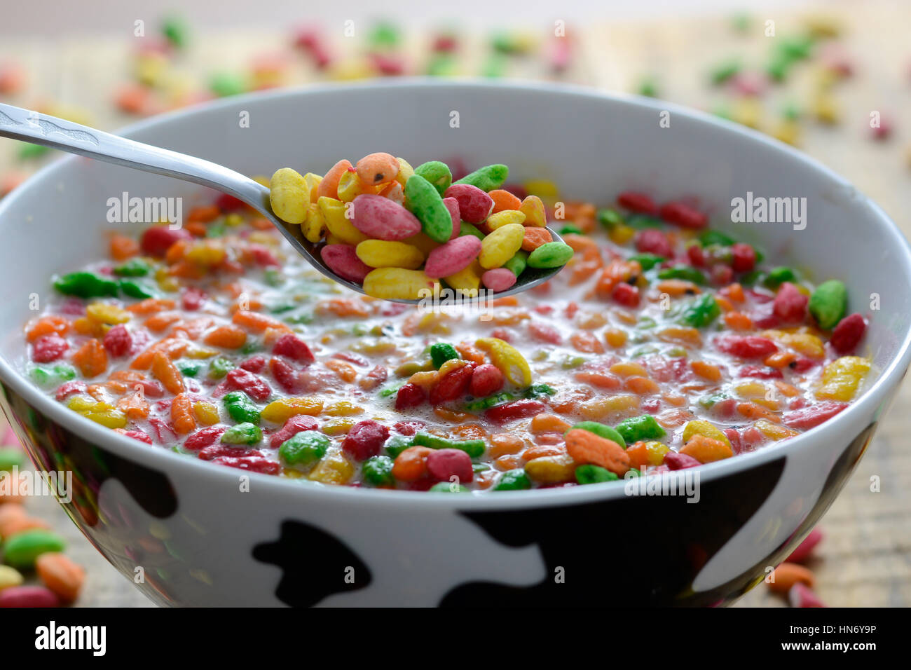 Prepared breakfast with colorful puffed rice with spilled rice in the background Stock Photo