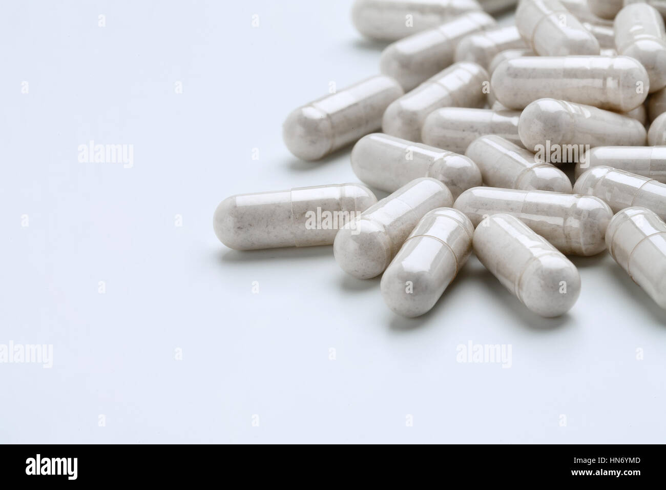 Pile of white capsules probiotic powder inside. Copy space. High resolution product. Health care concept Stock Photo