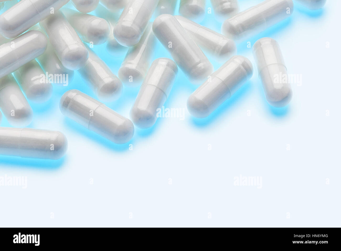 Heap of glowing capsules on white background. Copy space. High resolution product. Health care concept Stock Photo