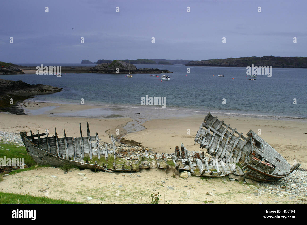 An old wrecked wooden boat on the shore of Highland in Scotland with ...