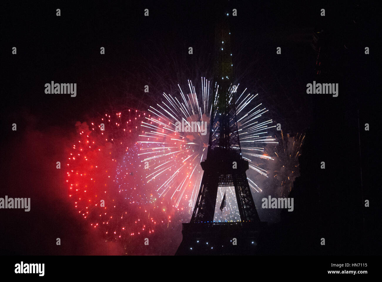 Fireworks behind Eiffel Tower on Bastilia Day in Paris Stock Photo