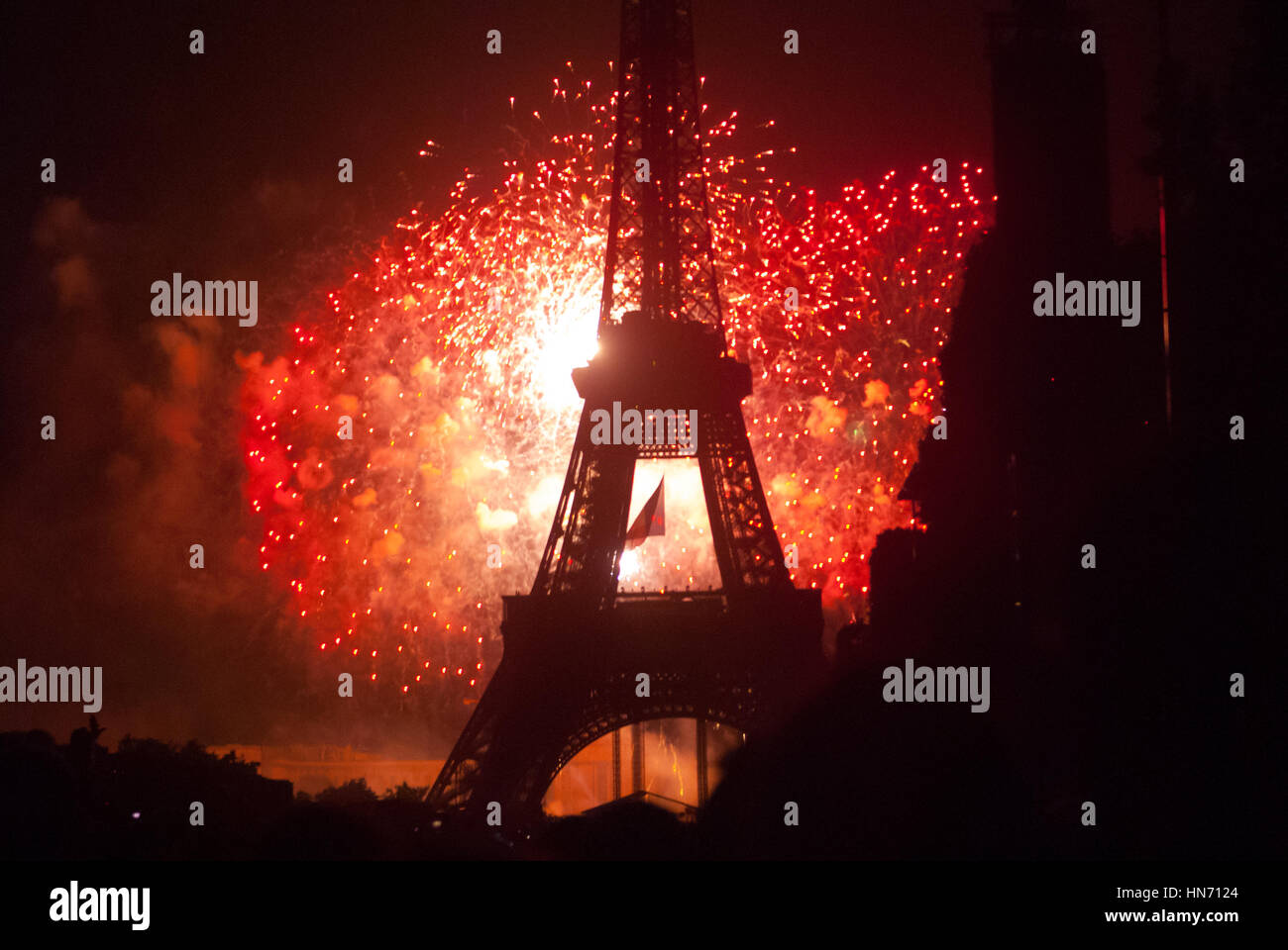 Fireworks behind Eiffel Tower on Bastilia Day in Paris Stock Photo