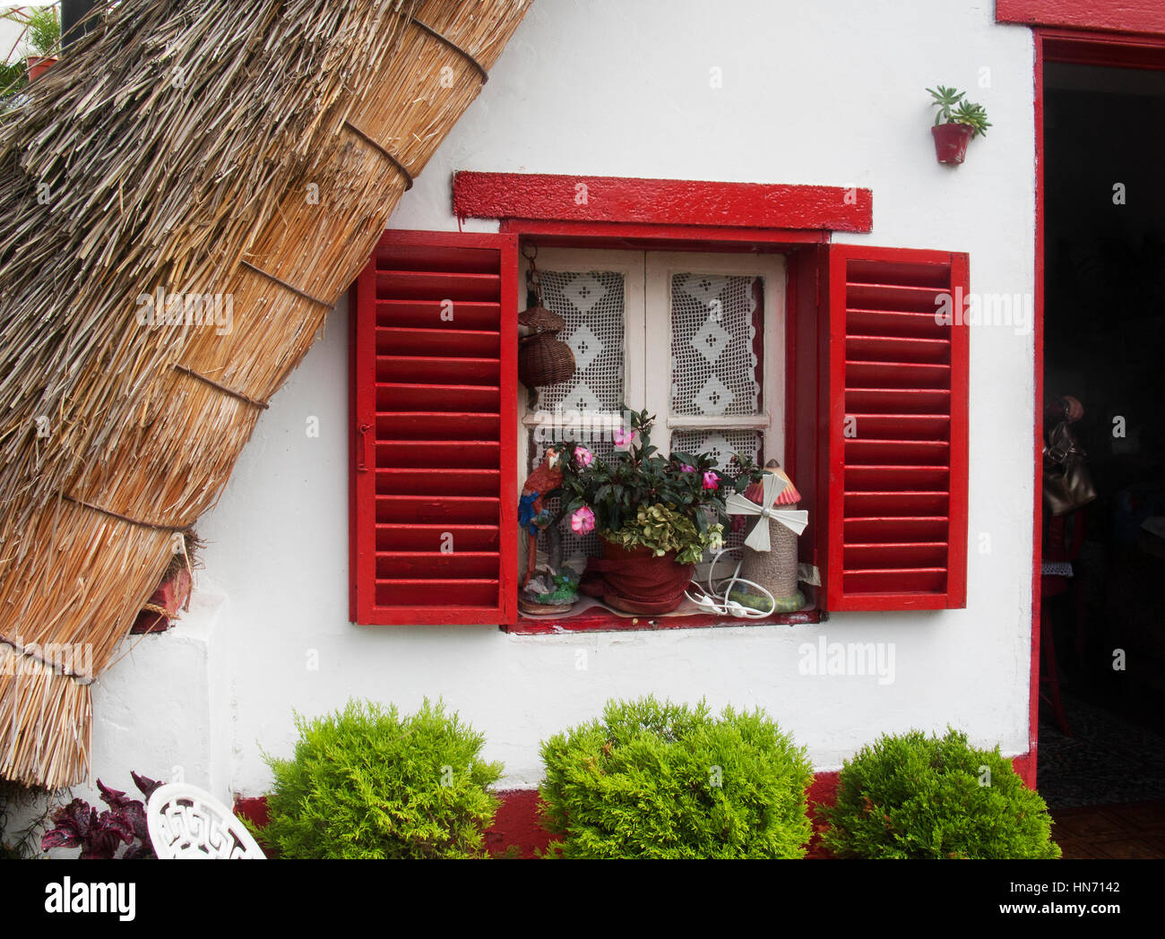 Window detail of a traditional thatched triangular house in the village of Santana, Madeira. Stock Photo