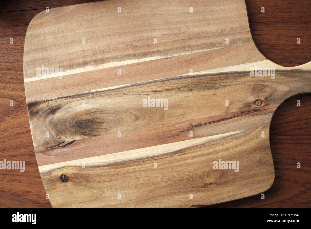 Cutting board on brown wooden table Stock Photo