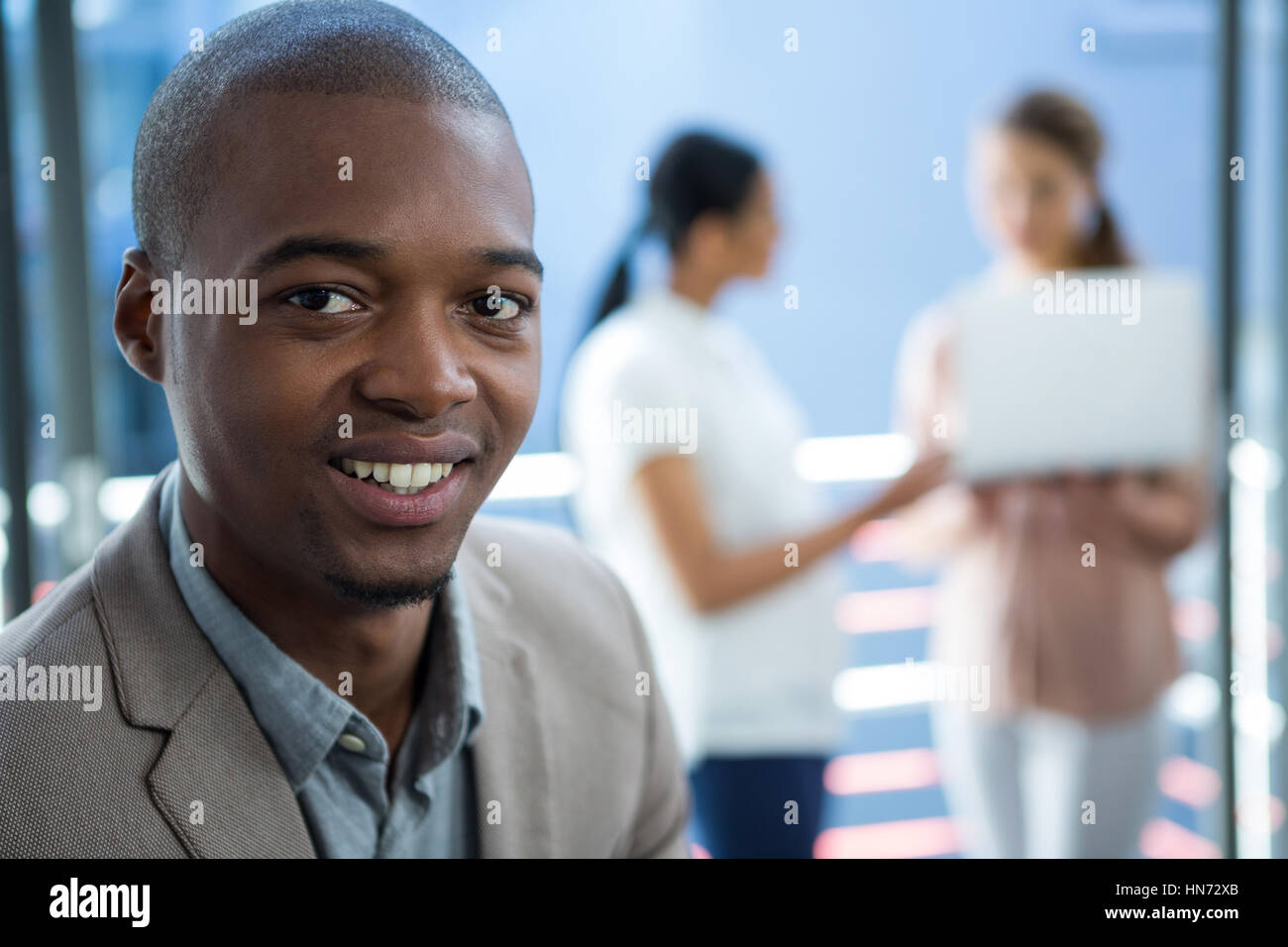 Portrait of business executive smiling in office Stock Photo - Alamy