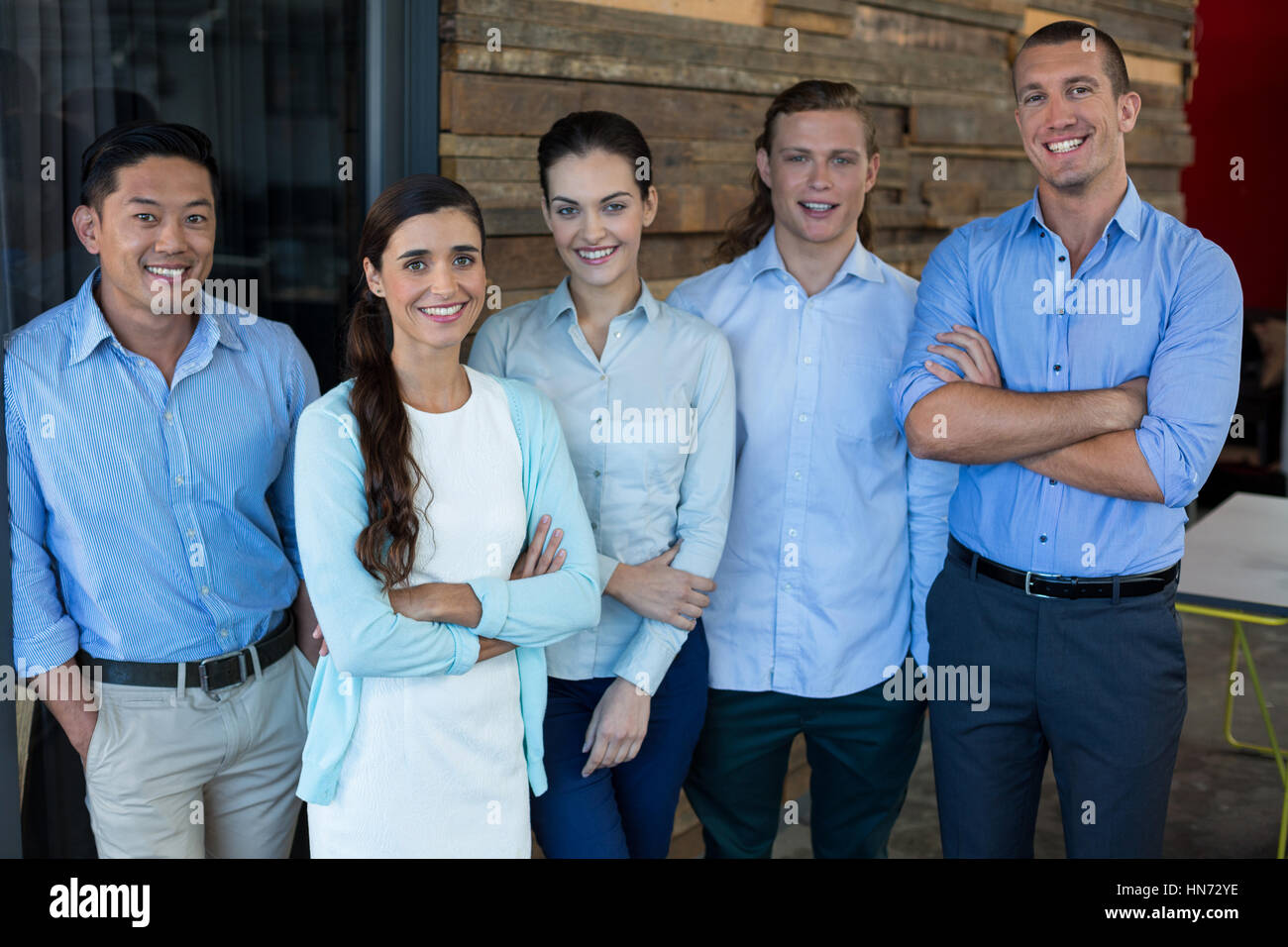 Portrait of businesspeople standing together in office Stock Photo - Alamy