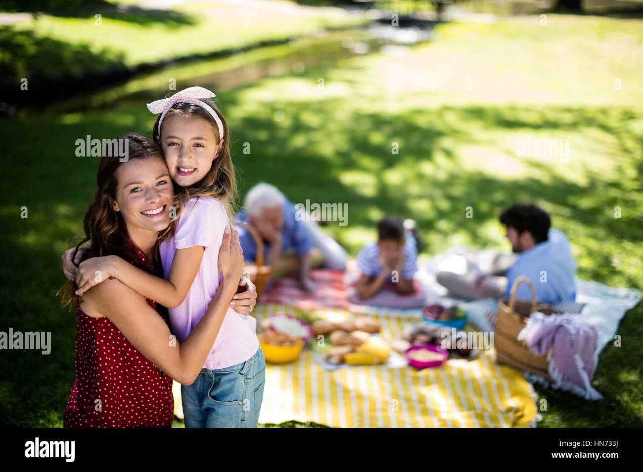 Happy family enjoying in park on sunny a day Stock Photo - Alamy