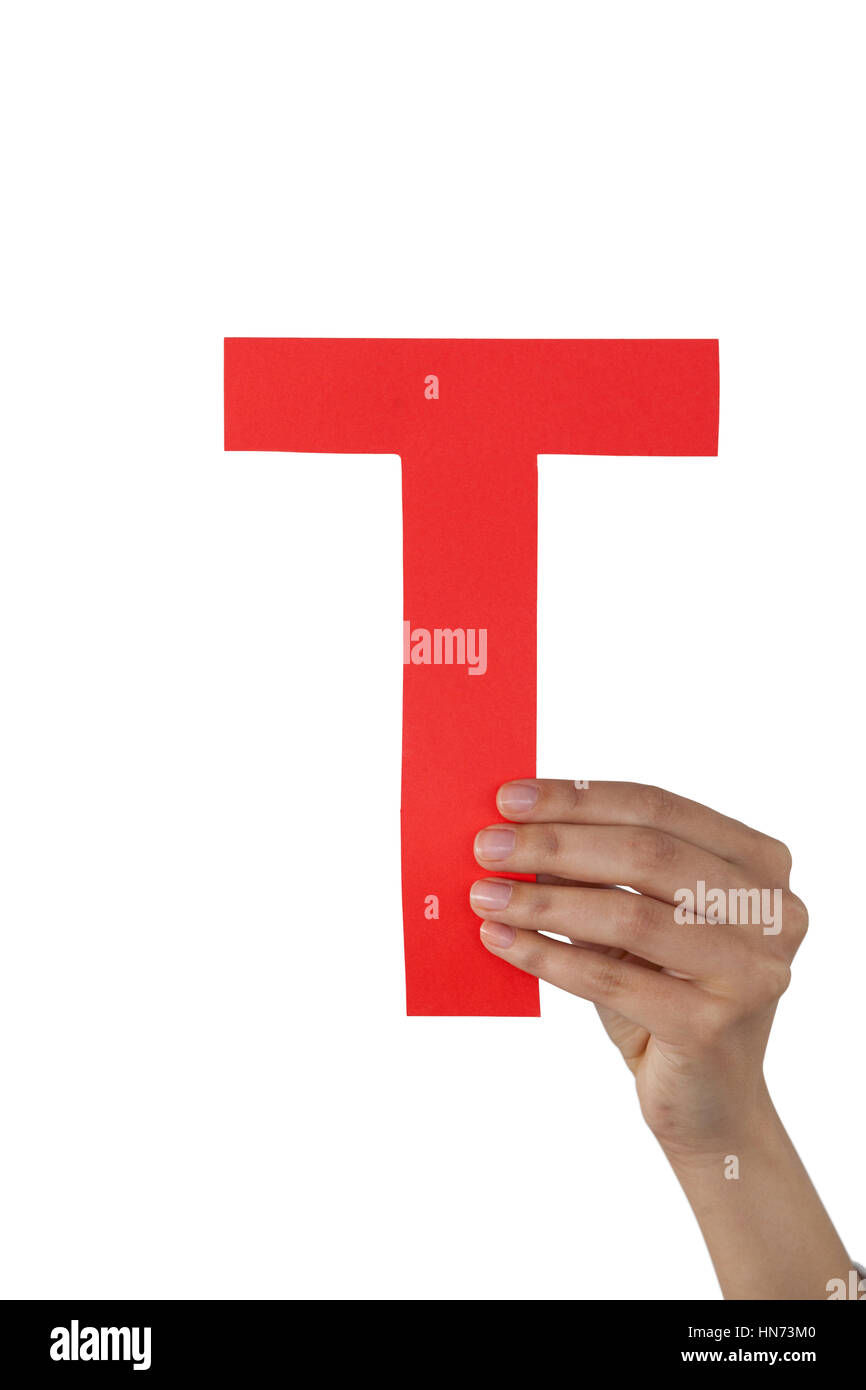 Close-up of businesswoman holding alphabet t against white background Stock Photo