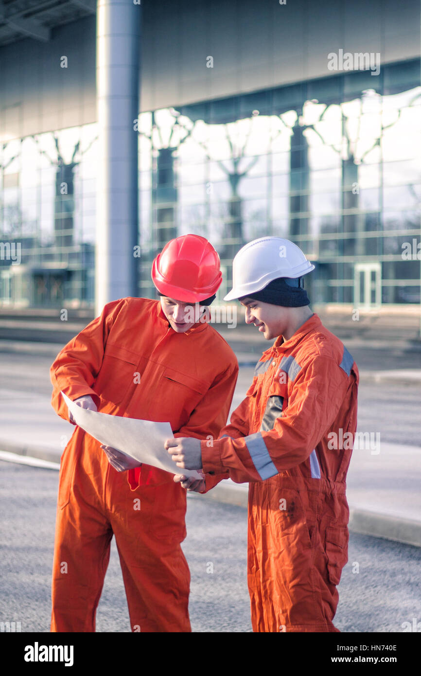 Team Of Young Engineers Discussing A Construction Project Stock Photo