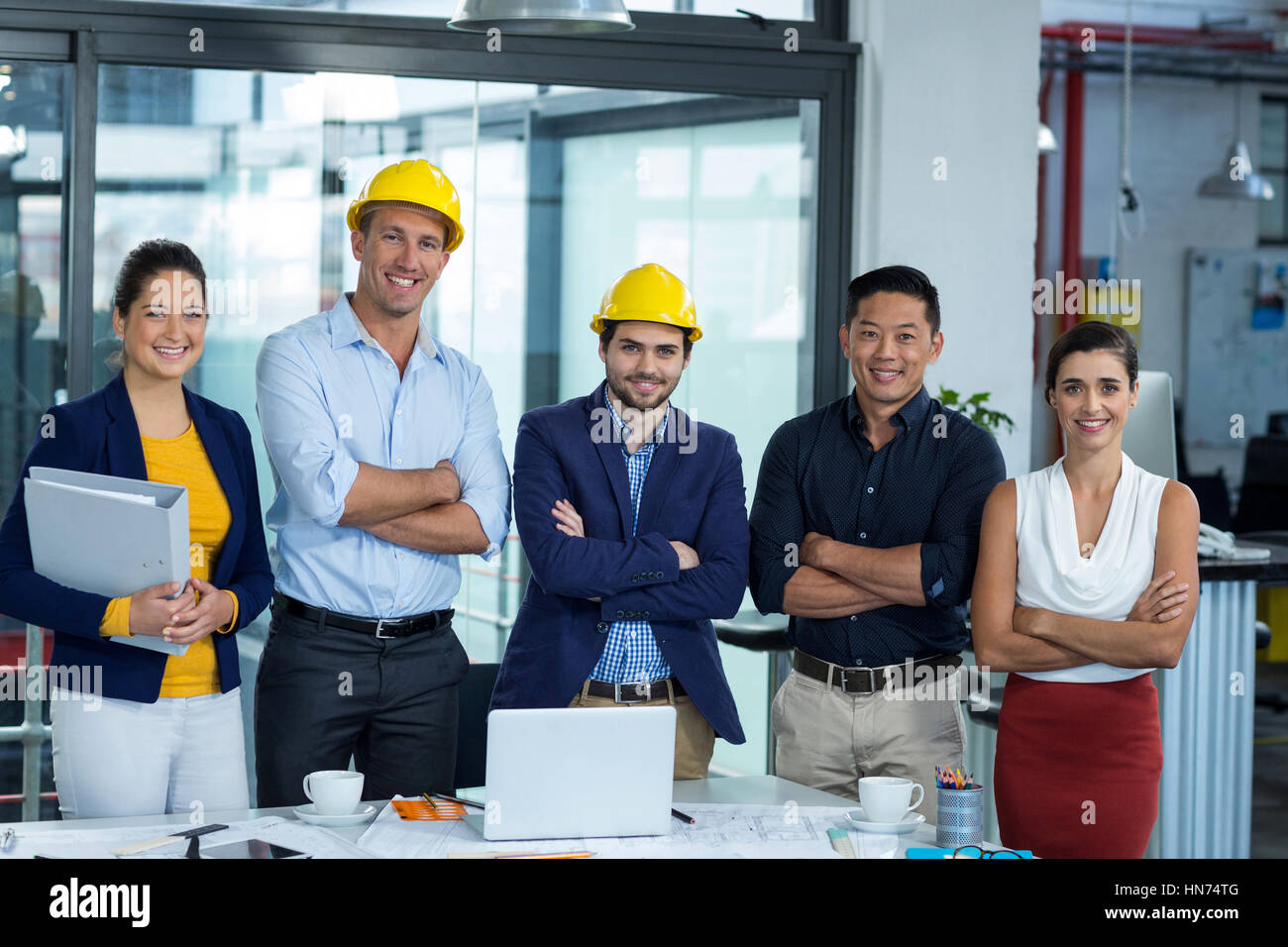 Portrait of business executives standing together in office Stock Photo ...