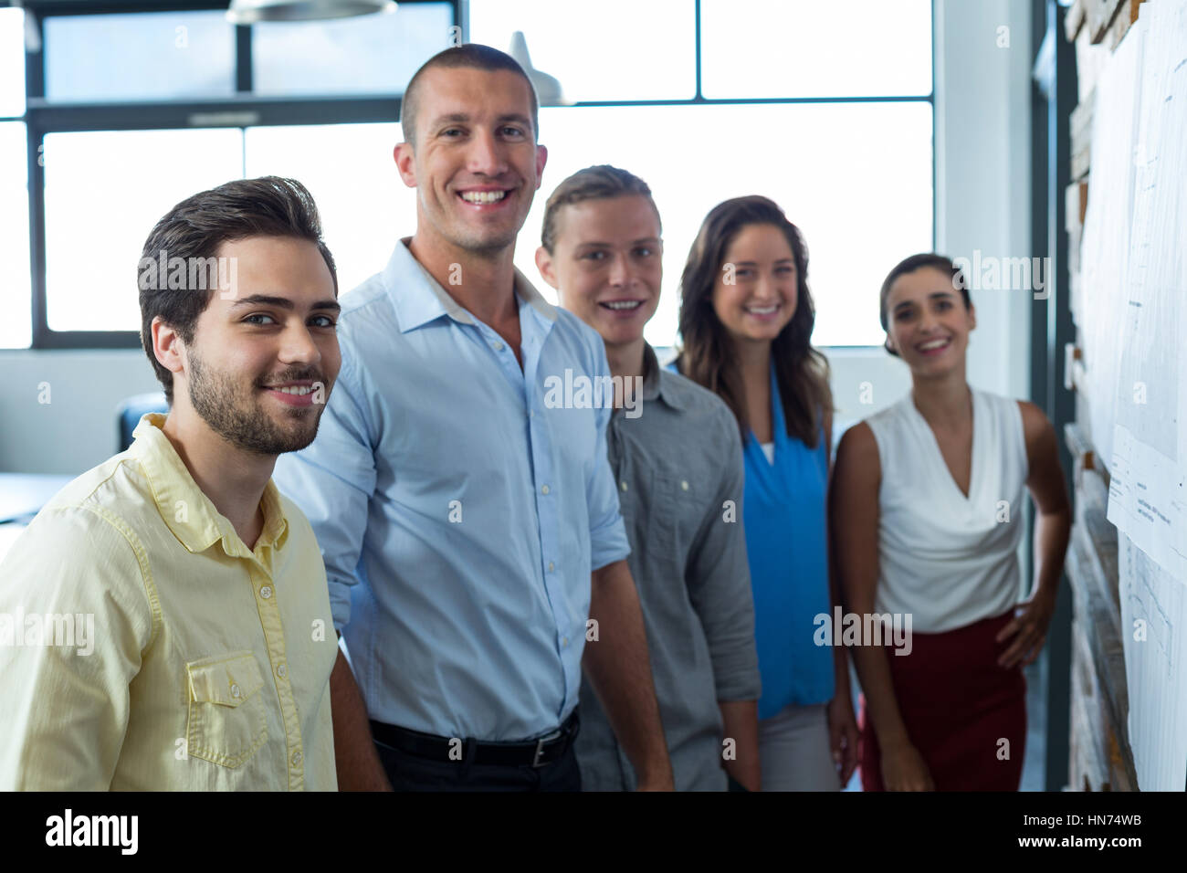 Portrait of smiling business executives standing in office Stock Photo ...