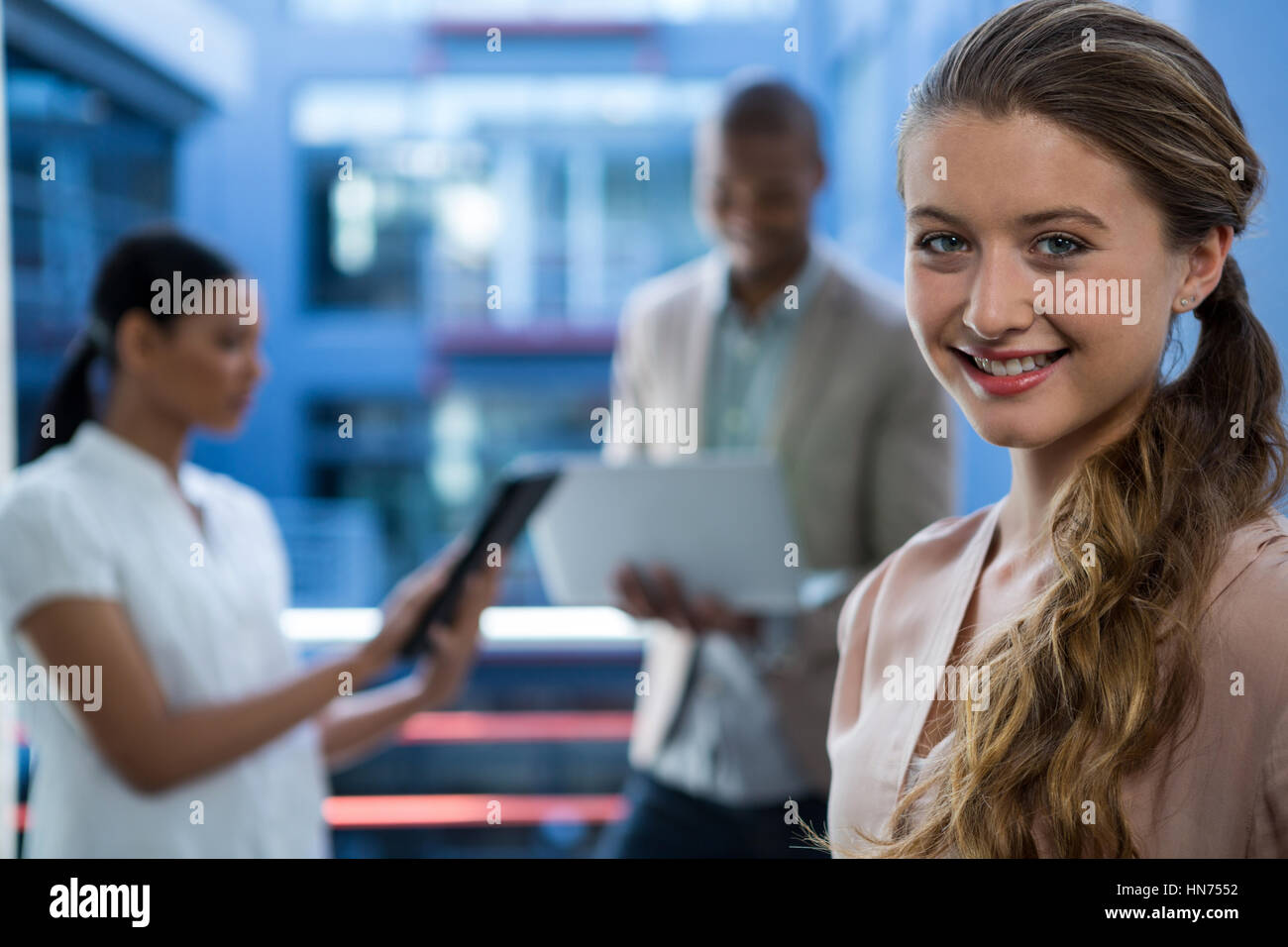 Portrait of beautiful business executive smiling in office Stock Photo ...